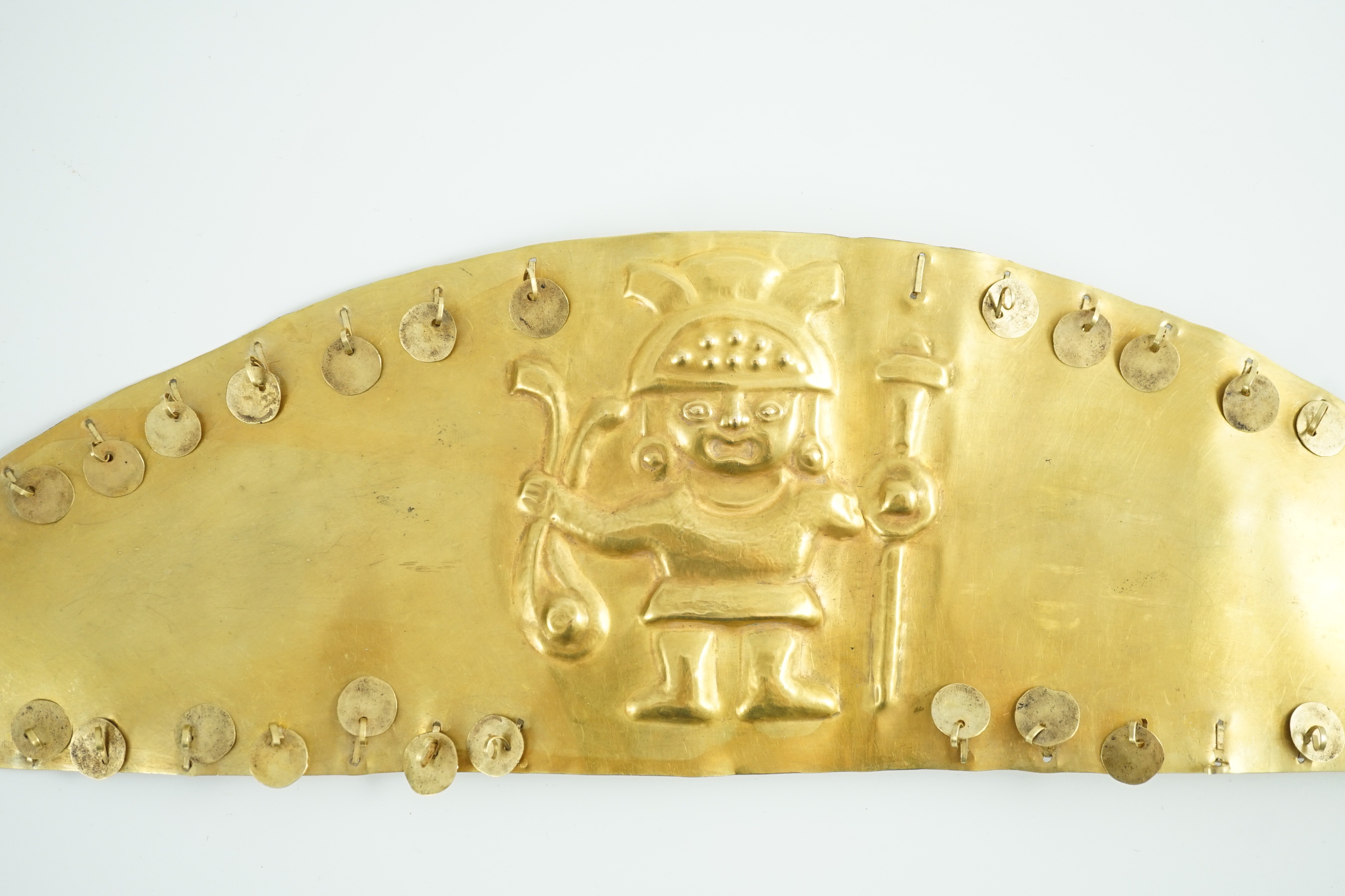 A rare pre-Columbian sheet gold headdress or breast plate, possibly Moche culture, Northern Peru, A.D. 200 - 850, 36cm wide 9.7cm high, weight 130g